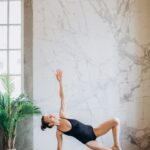 Woman performing a side plank variation to improve core stability, balance and proprioception